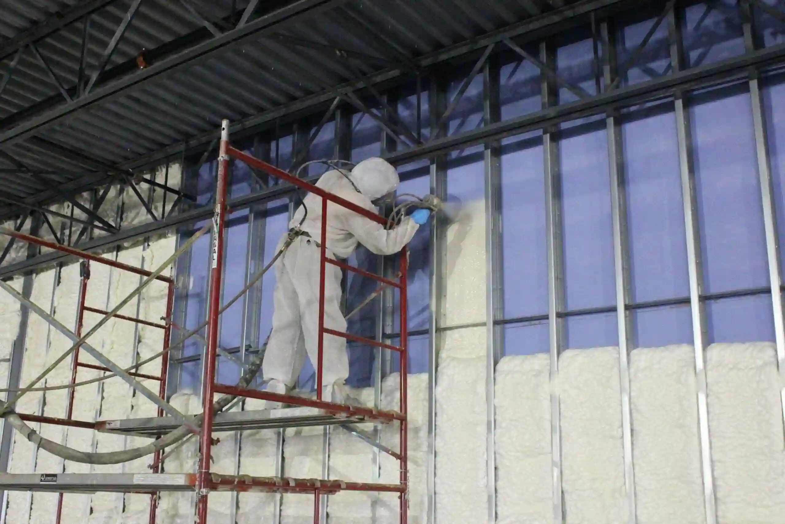 Sebastian Spray Foam technician applying spray foam insulation on a commercial building