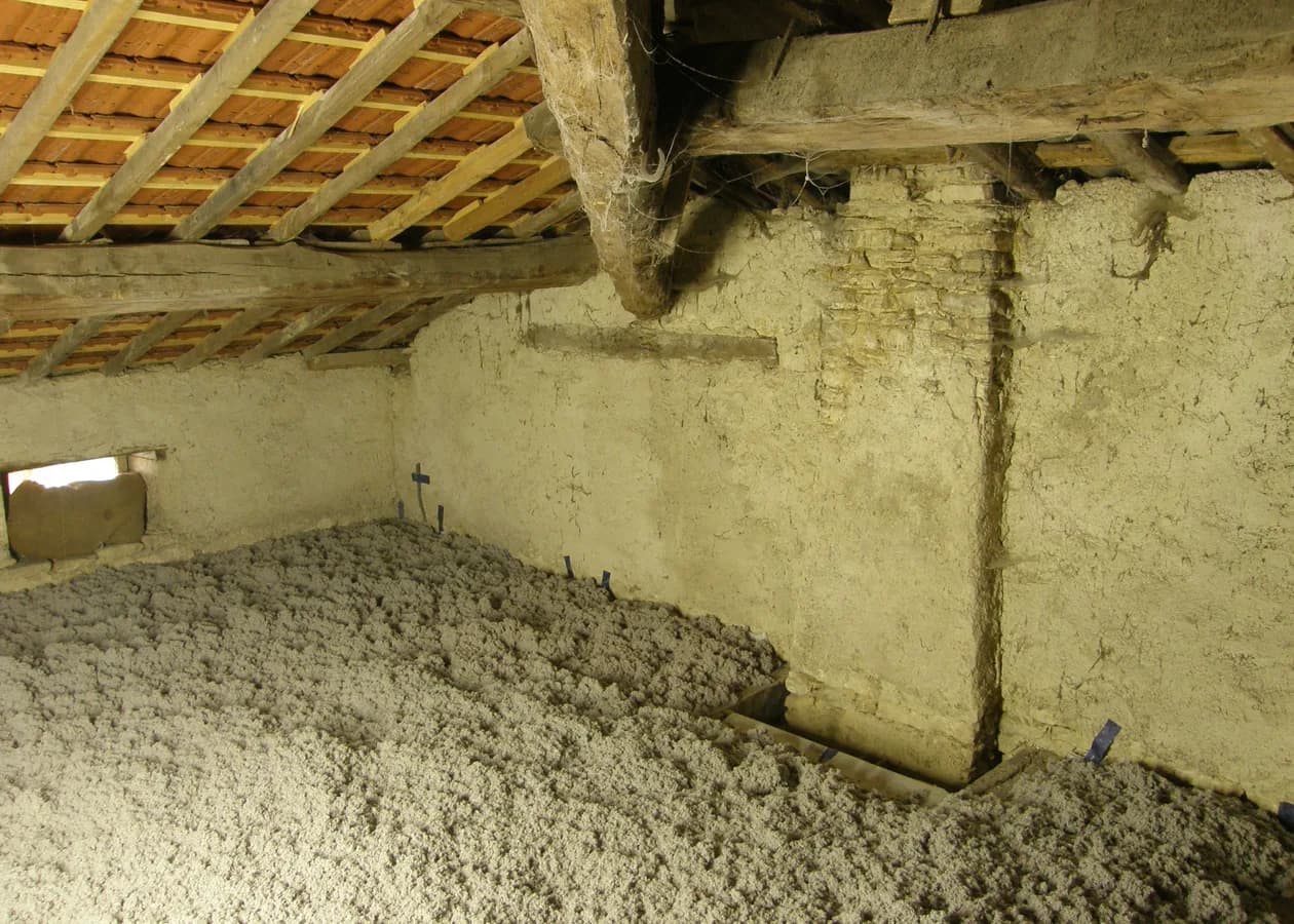 An attic floor covered in freshly blown cellulose insulation
