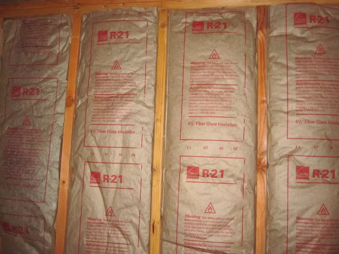Kraft-faced R-21 fiberglass batts installed between wall studs