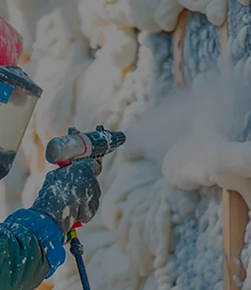 Spray gun applying closed-cell foam, the seal that closes off a crawl space